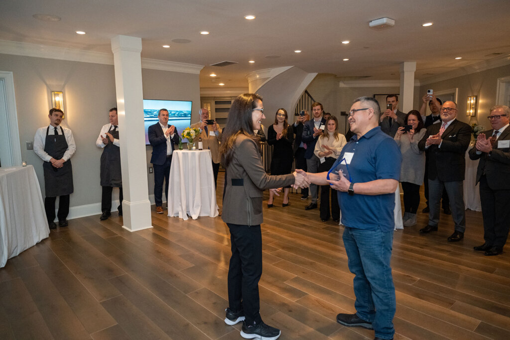 Rep Mary Petola congratulates winner Doug Redfox at the Alaska Broadband Visionary Award ceremony