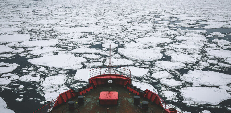 Icebreaker going through Arctic Ocean where the fiber optic cable route travels