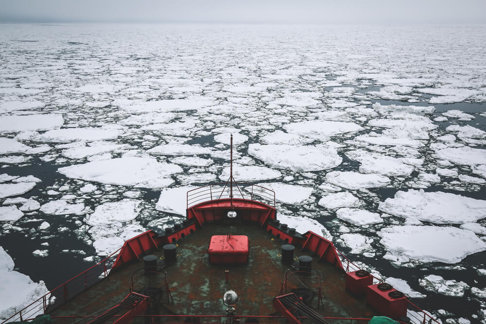 Icebreaker going through Arctic Ocean where the fiber optic cable route travels