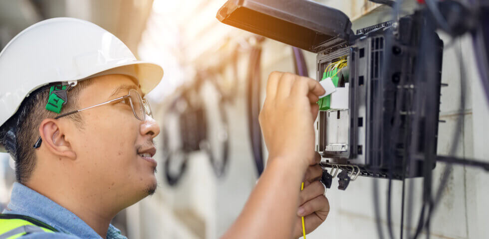 Alaskan fiber optic installation worker installing fiber optic in alaskan communities