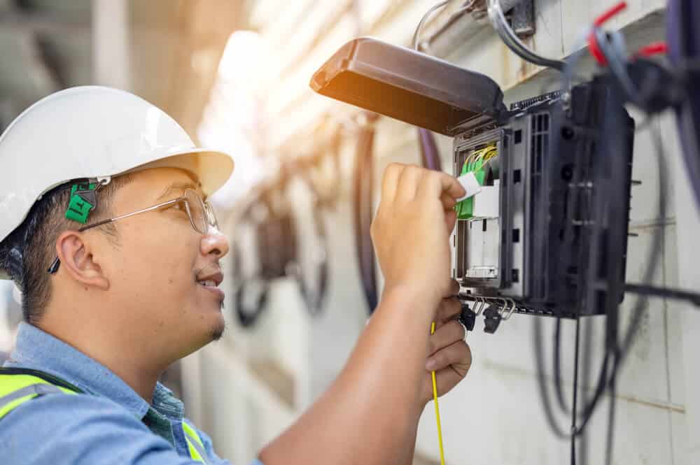 Alaskan fiber optic installation worker installing fiber optic in alaskan communities