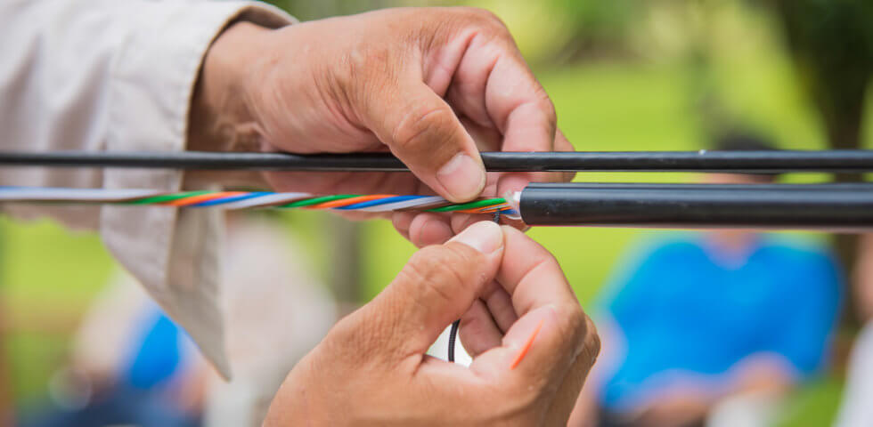Person constructing a high quality fiber optic cable