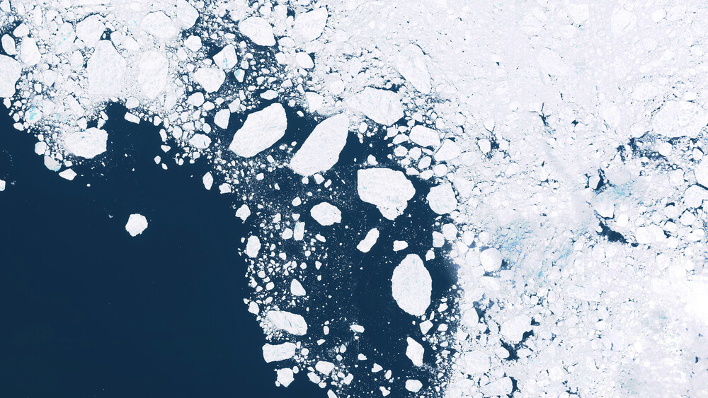Aerial view of sea ice breaking up.  Satellites help us observe the effects of climate change.
