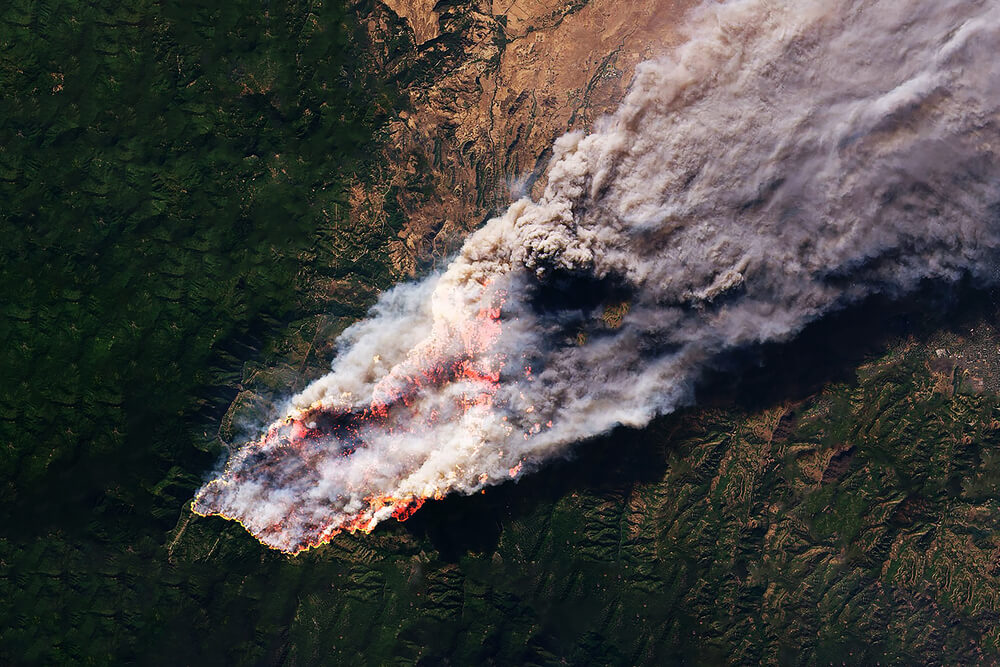Aerial view of forest fire natural disaster. Satellite data can help manage these events.