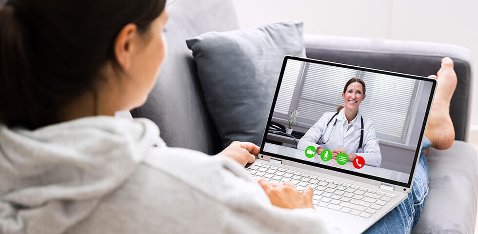 Young woman using telemedicine from the comfort of her couch via reliable broadband